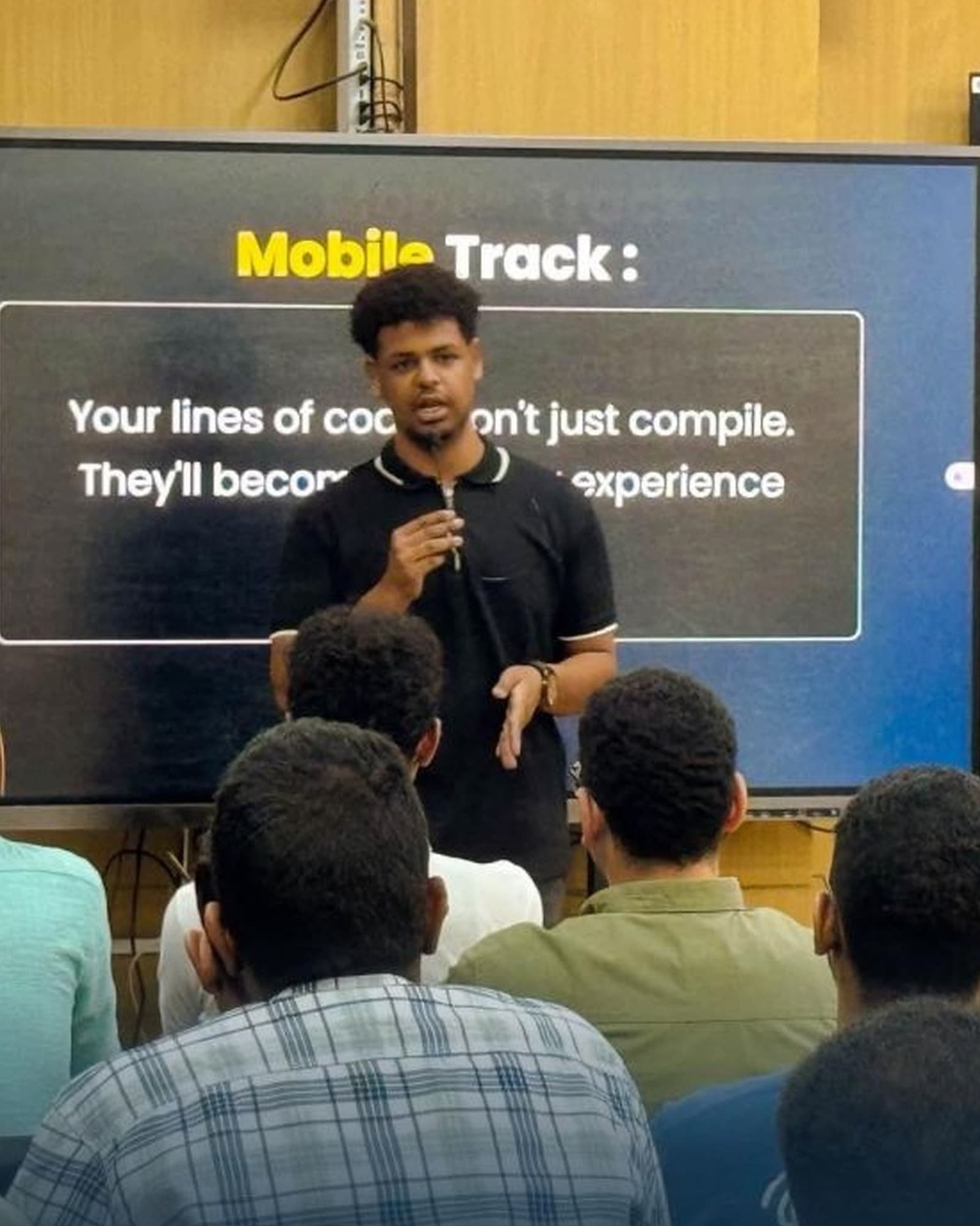 Ebrahim Hassan presenting to students during a mobile development session