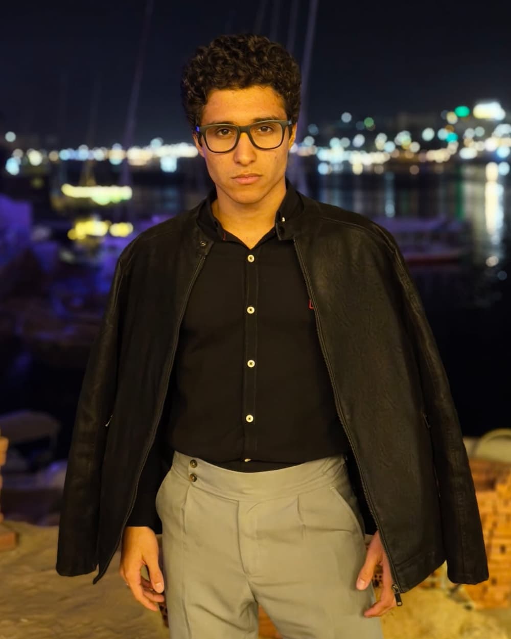 Omar Essam in a black jacket outdoors at night